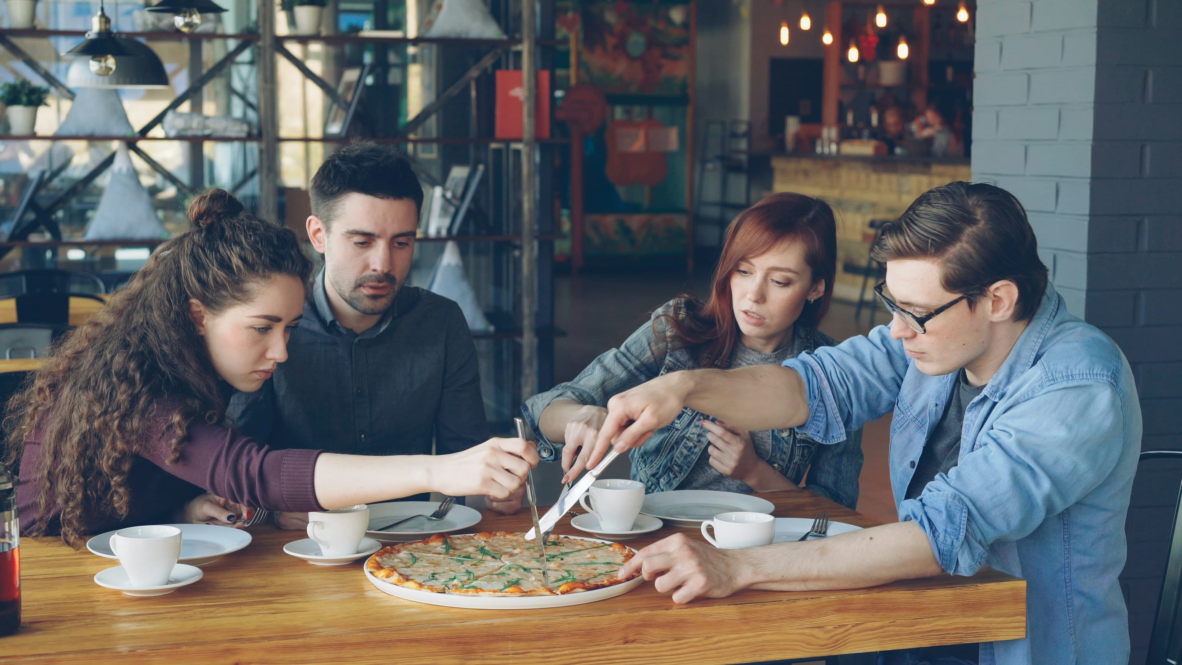 Friends sharing a meal together at a restaurant